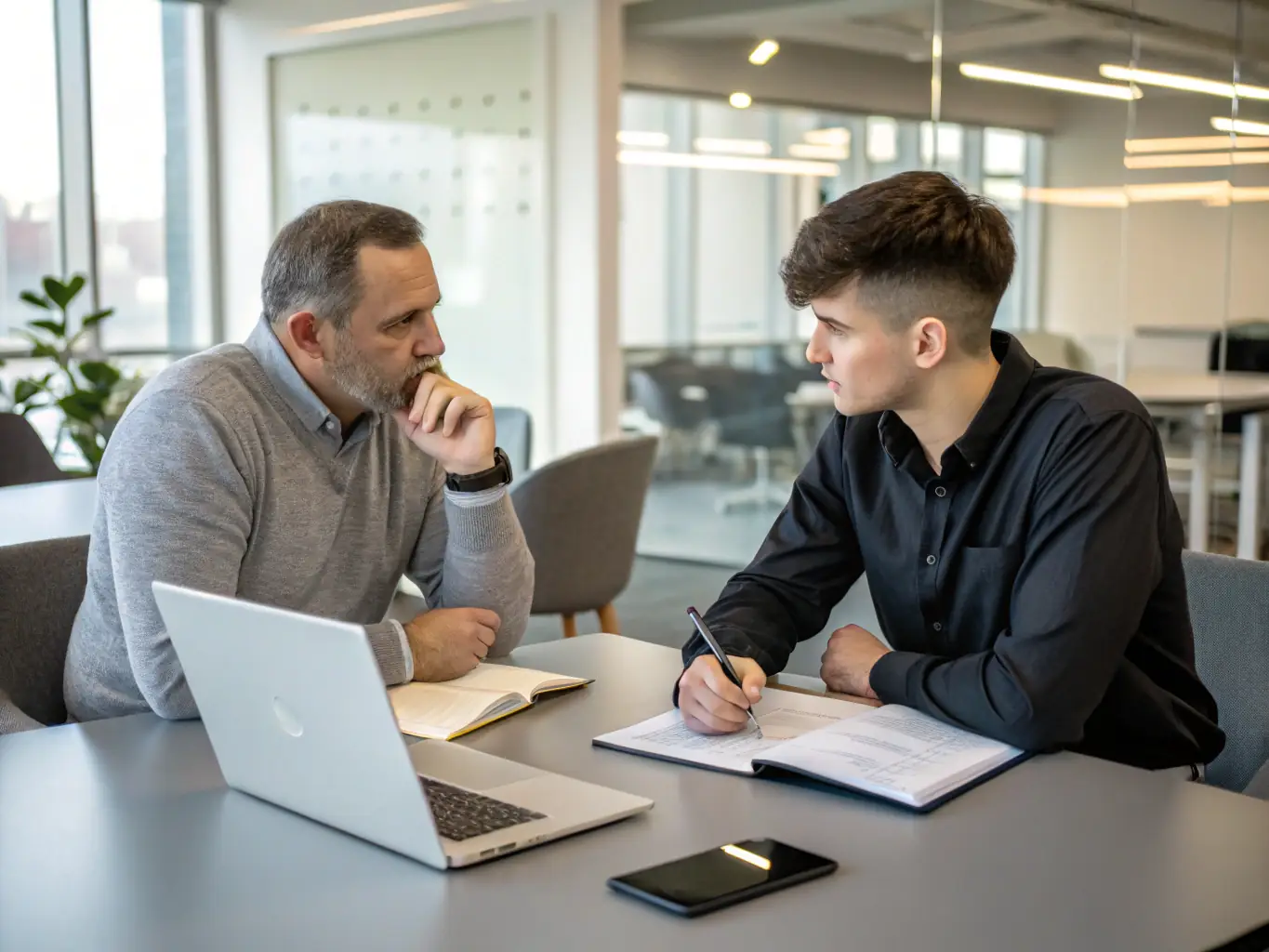 A business mentor is in a one-on-one session with a business leader, discussing strategic planning and leadership development.
